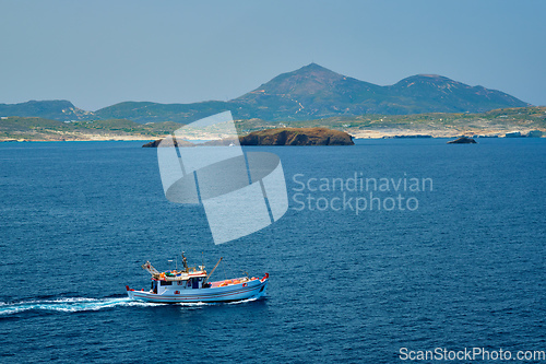 Image of Greek fishing boat in Aegean sea near Milos island, Greece