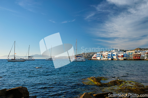 Image of Sunset in Mykonos, Greece, with cruise ship and yachts in the harbor