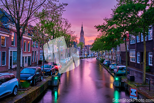 Image of Canal with parked along cars in Delft town, Netherlands