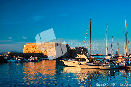 Image of Venetian Fort in Heraklion and moored fishing boats, Crete Island, Greece