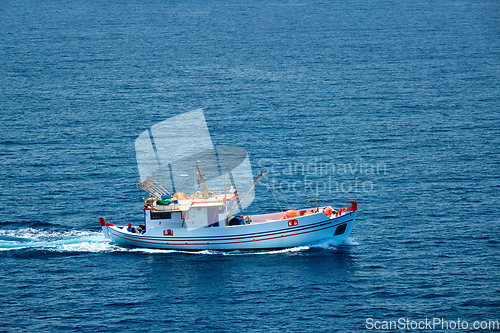 Image of Greek fishing boat in Aegean sea near Milos island, Greece
