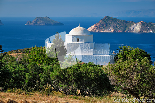 Image of View of Milos island and Greek Orthodox traditional whitewashed church in Greece