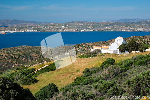 Image of View of Milos island and Greek Orthodox traditional whitewashed church in Greece