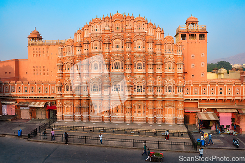 Image of Famous historical landmak pink Hawa Mahal Palace of Winds with people and transport. Jaipur, Rajasthan, India