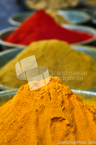 Image of Turmeric curcuma powder and chili powder in spices market in India