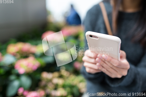 Image of Woman use of cellphone at outdoor