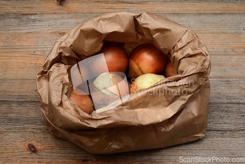 Image of onion bulbs in a kraft paper bag