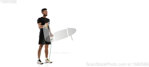 Image of Caucasian professional sportsman training isolated on white studio background. Muscular, sportive man practicing.