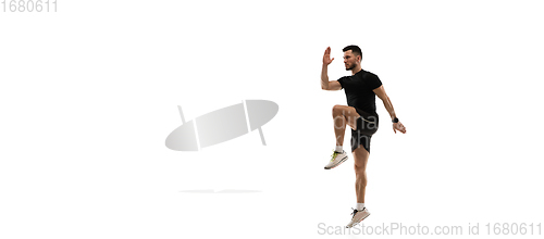 Image of Caucasian professional sportsman training isolated on white studio background. Muscular, sportive man practicing.
