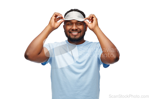 Image of happy african american man with eye sleeping mask