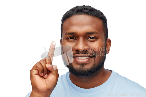 Image of happy african american man showing moisturizer