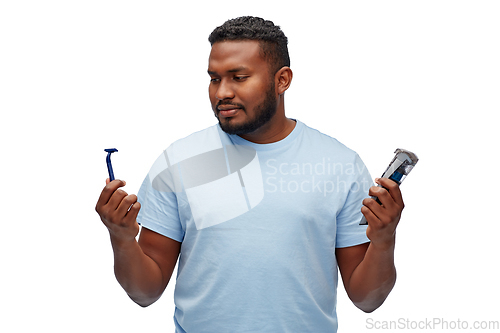 Image of african man with razor blade and trimmer