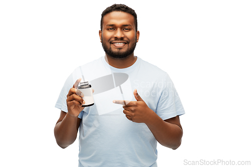 Image of smiling african american man with medicine jar