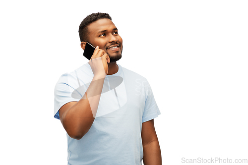 Image of happy african american man calling on smartphone