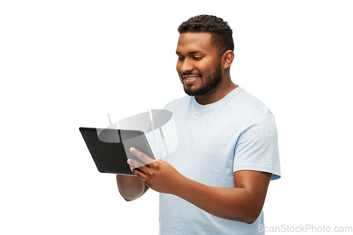 Image of happy african american man with tablet computer