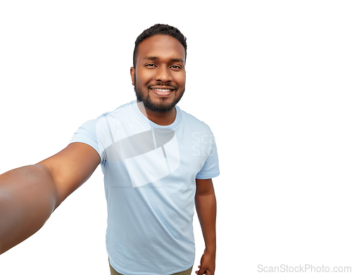 Image of smiling young african american man taking selfie