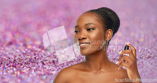 Image of young african american woman with perfume