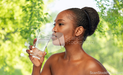 Image of young african american woman with glass of water