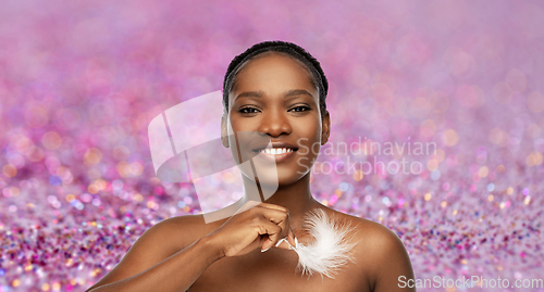 Image of happy african american woman with feather