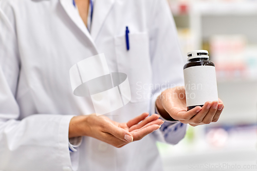 Image of close up of pharmacist with medicine at pharmacy