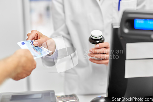 Image of close up of pharmacist selling drug at pharmacy