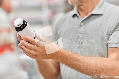 Image of close up of customer choosing medicine at pharmacy