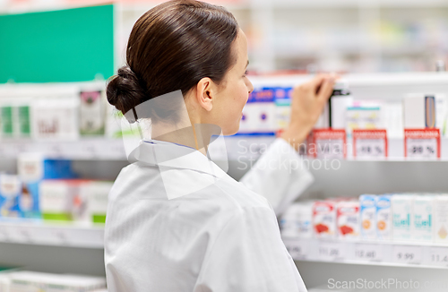 Image of female pharmacist with medicine at pharmacy