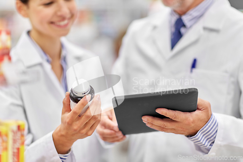 Image of pharmacists with tablet pc and medicine