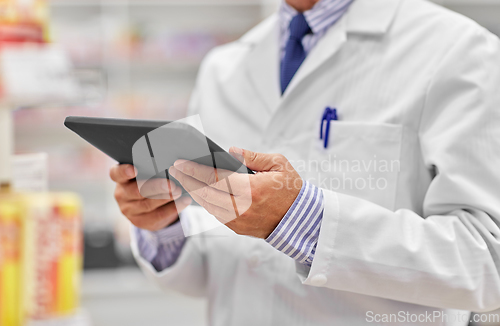 Image of close up of senior pharmacist with tablet pc