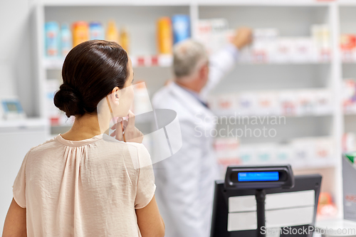 Image of woman buying medicine at pharmacy