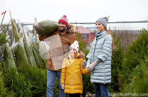 Image of happy family buying christmas tree at market