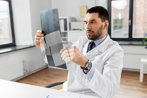 Image of male doctor with x-ray of spine at hospital