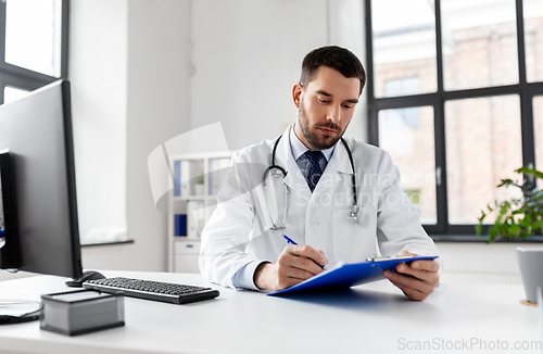 Image of male doctor with clipboard at hospital