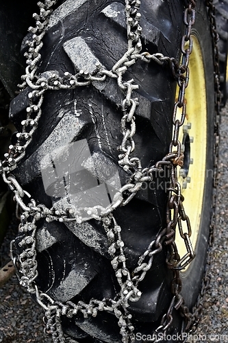 Image of wheel chains on the wheel of the tractor   