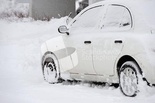 Image of car covered with snow after snowfall 