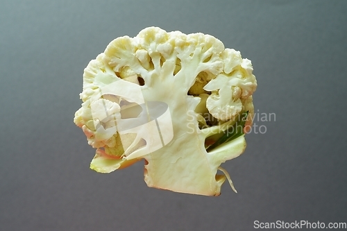 Image of section of a cauliflower on a gray background