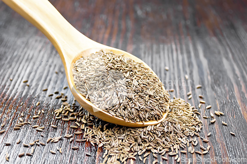 Image of Cumin seeds in spoon on wooden table