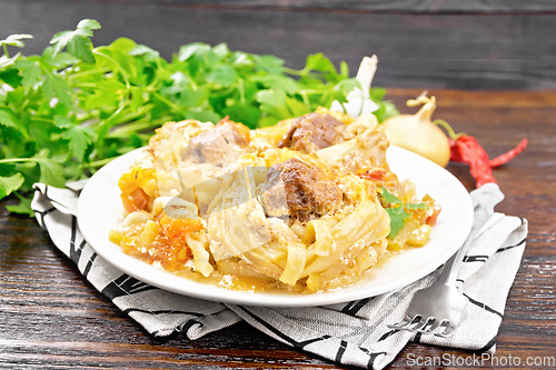 Image of Pasta with meatballs in plate on wooden board