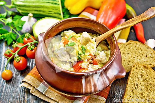 Image of Rice with chicken and vegetables in pot on table