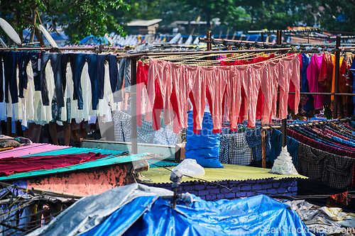 Image of Dhobi Ghat is an open air laundromat lavoir in Mumbai, India with laundry drying on ropes