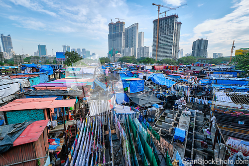 Image of Dhobi Ghat is an open air laundromat lavoir in Mumbai, India with laundry drying on ropes