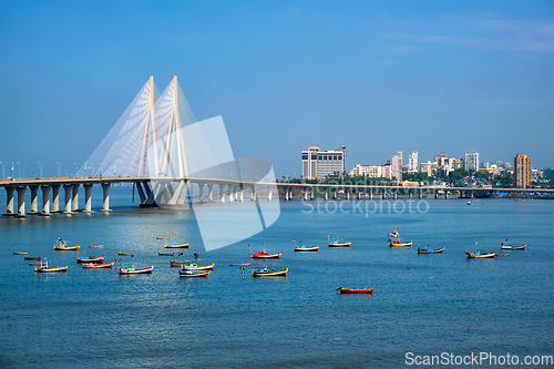 Image of Bandra - Worli Sea Link bridge with fishing boats view from Bandra fort. Mumbai, India