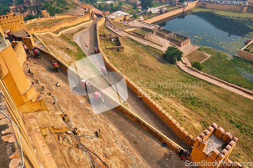 Image of Tourists riding elephants on ascend to Amer fort