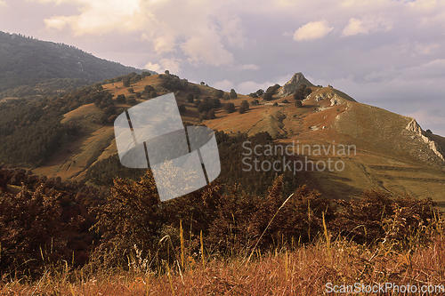 Image of Orange colors of sunset over hills