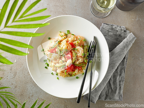 Image of plate of risotto with zucchini and prawns
