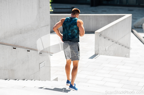 Image of young man running downstairs