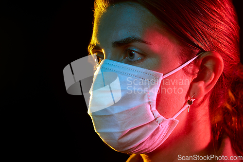 Image of young woman wearing protective medical mask