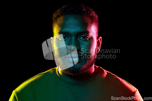 Image of young african american man over black background