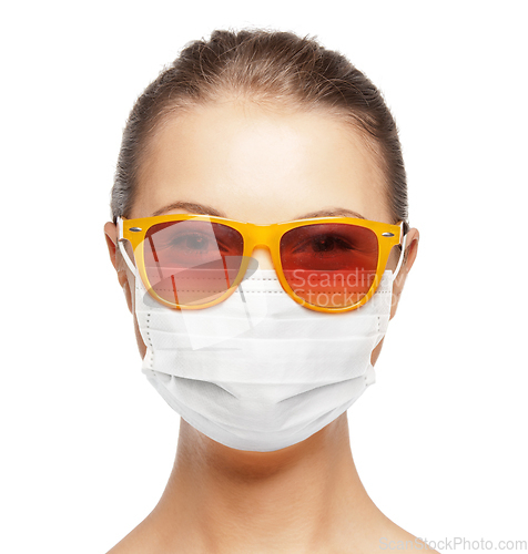 Image of teenage girl in medical mask and sunglasses