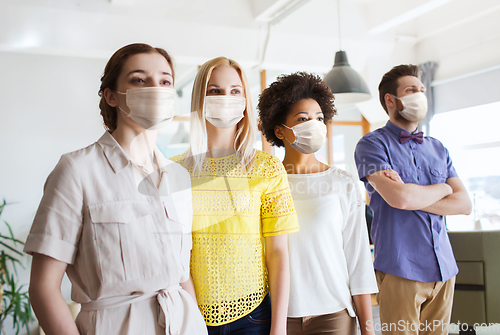 Image of business team in masks in office